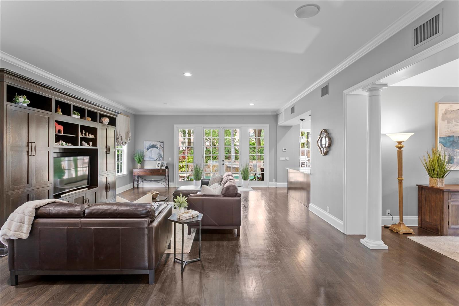 From the foyer, your eye is drawn into the expansive great room and out to the stunning outdoor oasis complete with a sparkling pool