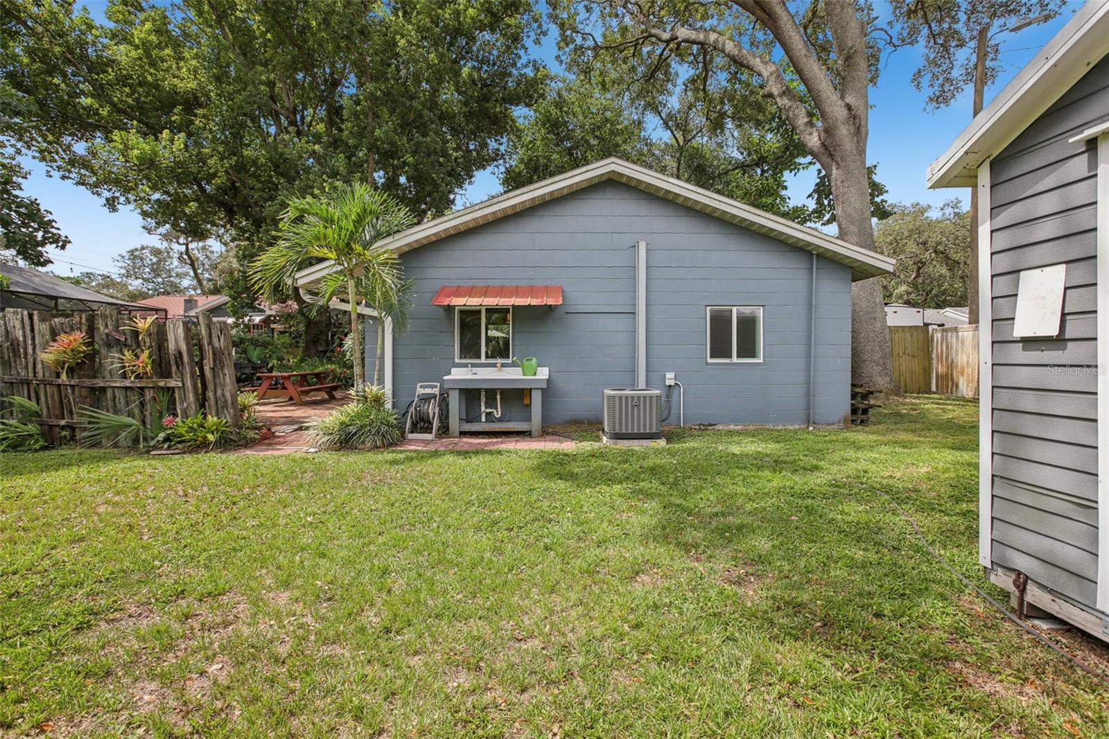 Side of Guest House, Sink, and Part of Shed