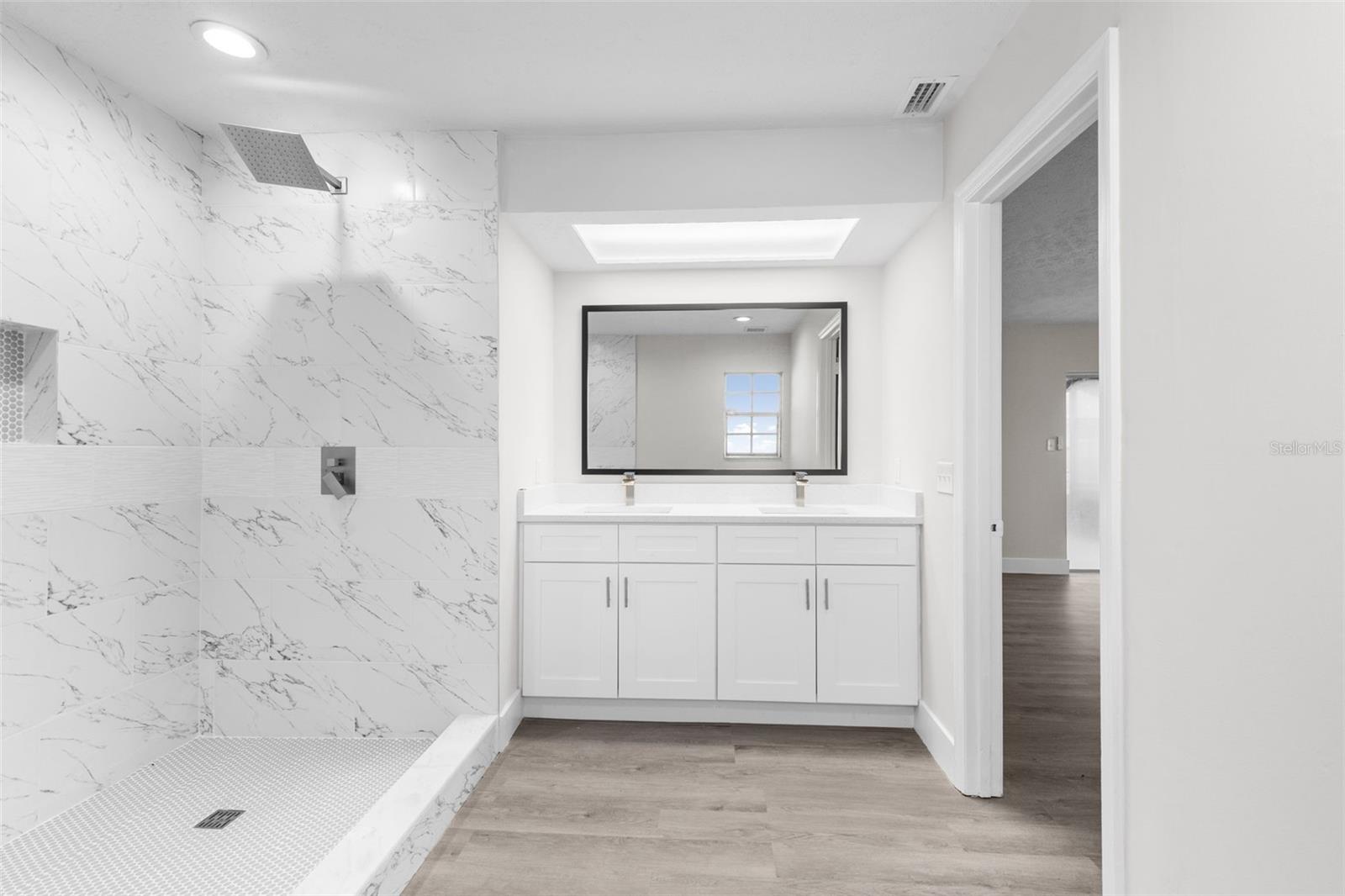Updated Dual Vanity with dual sink and quartz countertops.