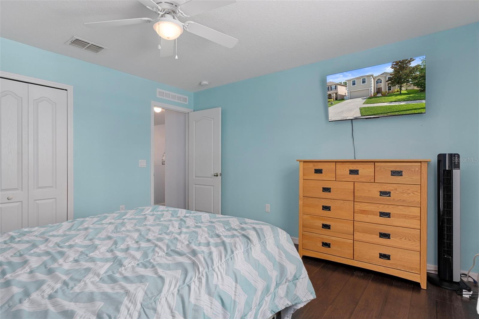 This guest bedroom has a fan/light and large closet