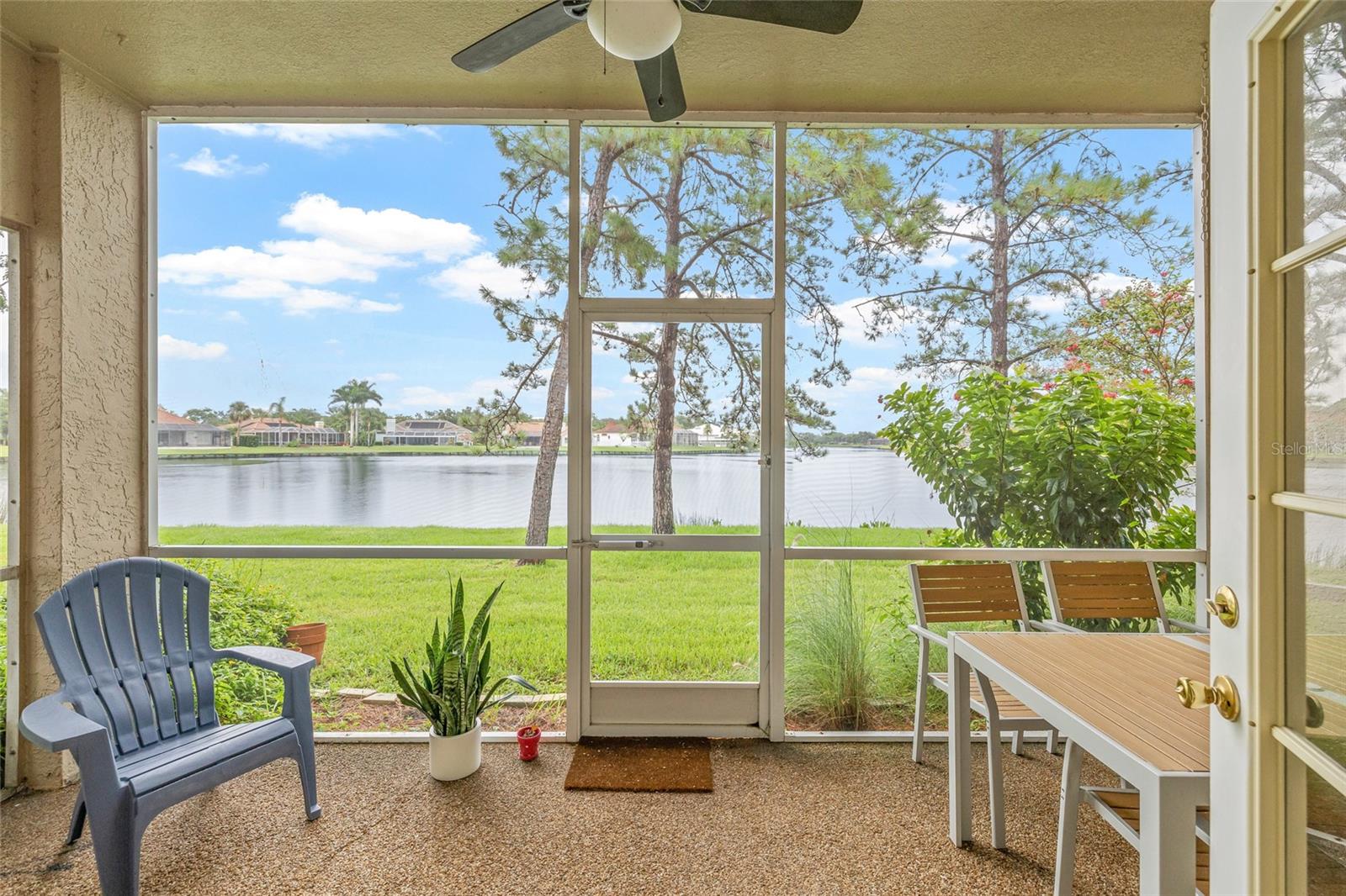 Fully screened rear porch with glistening views of the lake.