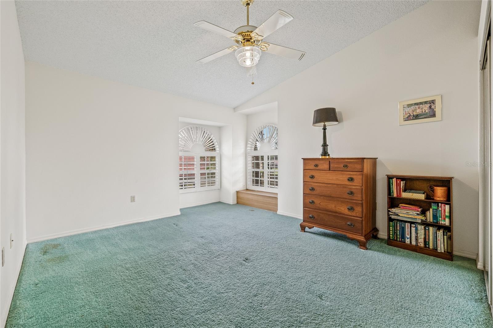 Bedroom 4 upstairs with a window seat overlooking the lake.