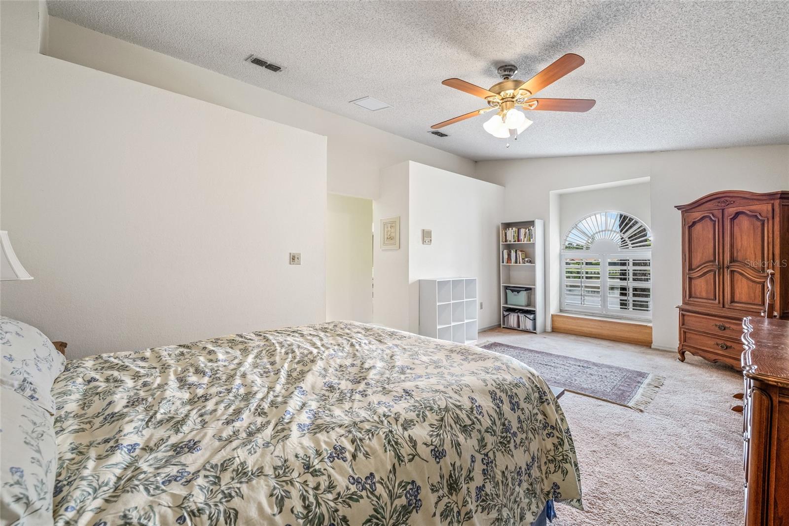 Primary bedroom, located upstairs, features an amazing lake view from bed.