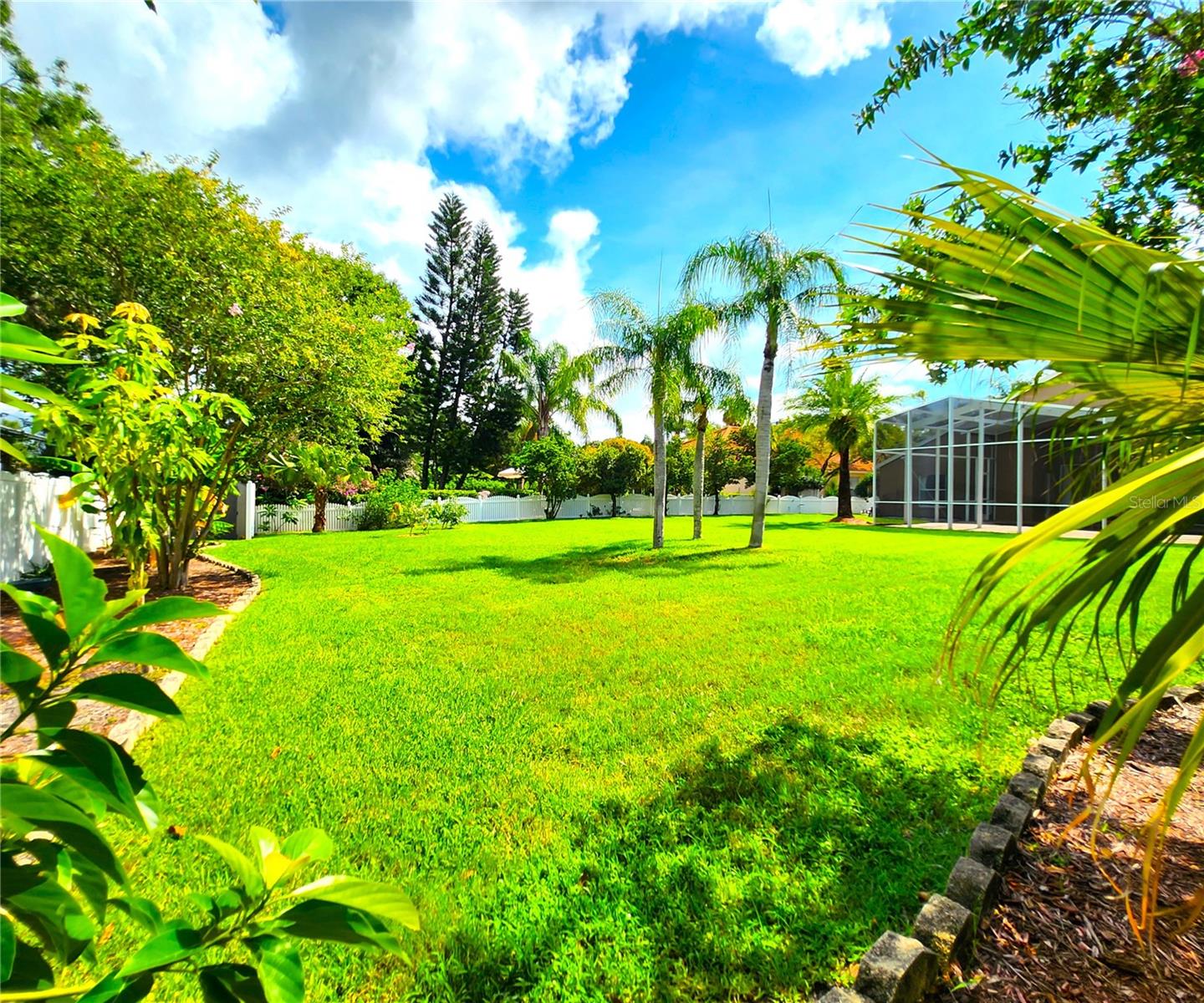 St. Augustine grass, irrigation front & back, fenced in, new mulch, manicured lawn