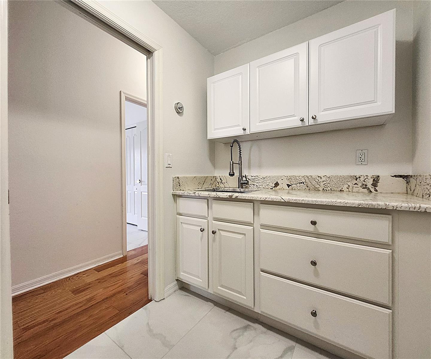 Inside Laundry Room: Cabinets, Granite Sink, Countertop, Washer & Dryer Hook-Ups
