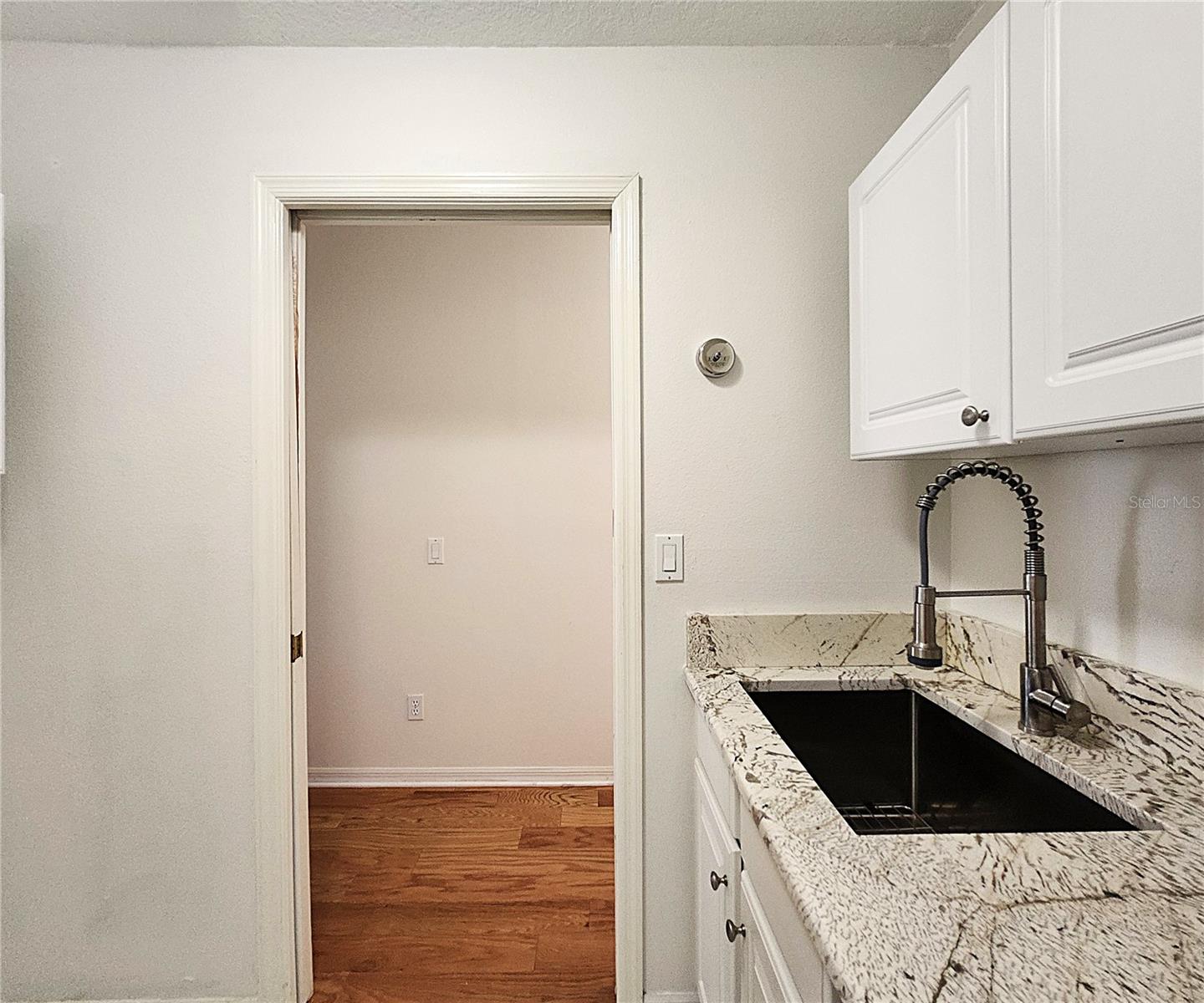 Inside Laundry Room: Cabinets, Granite Sink, Countertop, Washer & Dryer Hook-Ups
