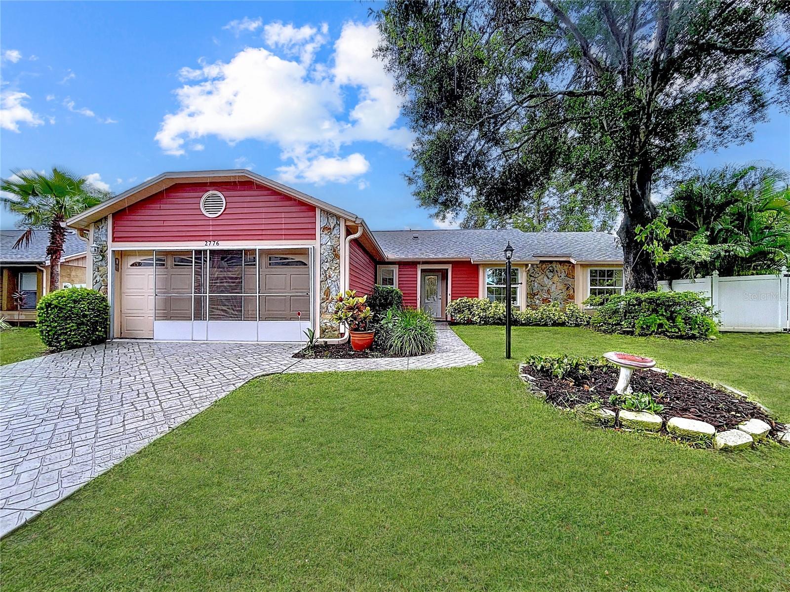 Charming curb appeal with bold red siding, stone accents, and mature landscaping. Set on a fully fenced lot, this home sits high and dry with no flood insurance required.