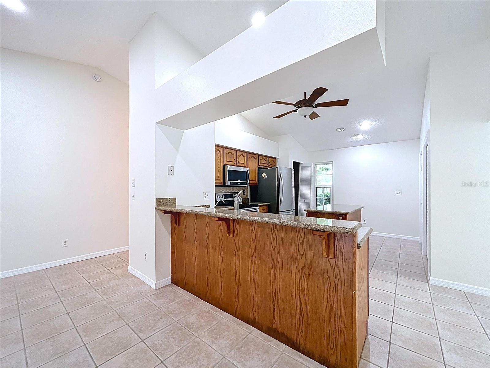The kitchen layout includes an extended granite peninsula, perfect for prepping meals or gathering with guests.