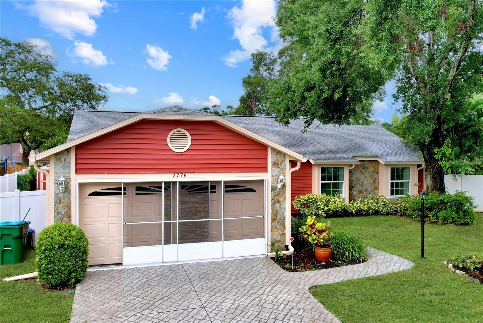 Durable STANEK hurricane-rated double-pane windows and screened garage doors combine functionality with safety.