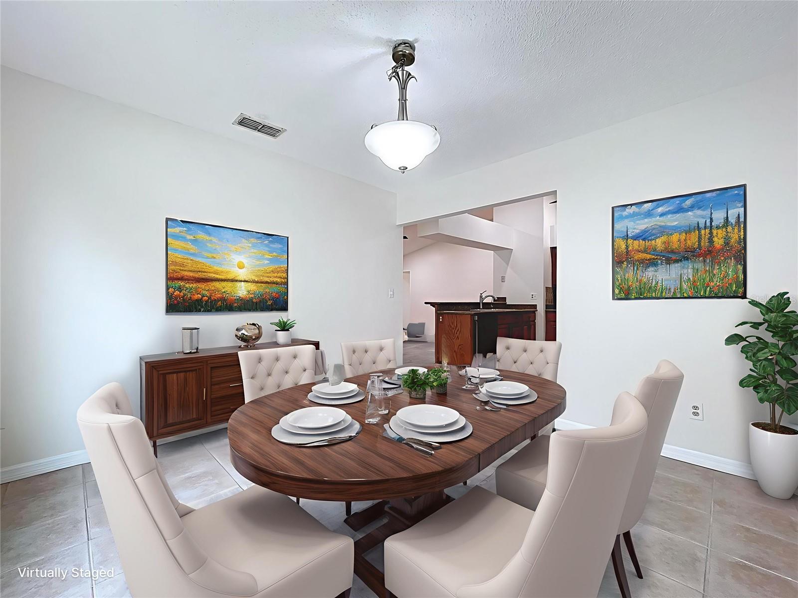 Centrally located off the kitchen, this light-filled dining room offers a versatile space for everyday meals or formal gatherings, with tile flooring and neutral walls for effortless style.