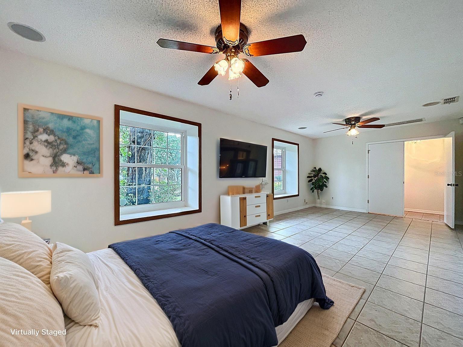 Shown with a larger furniture layout, this expanded third bedroom offers flexibility for guests, work-from-home space, or a relaxing owner's escape.