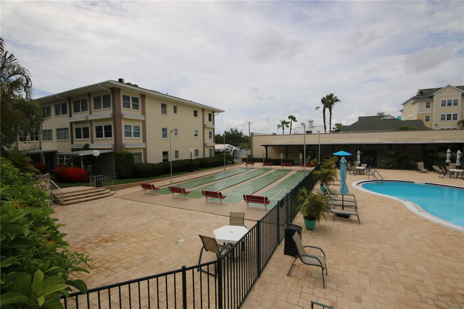 Shuffleboard and Pool area with Clubhouse in background