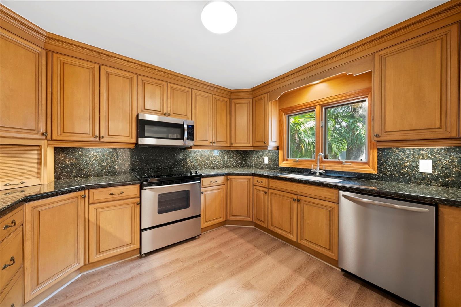 ample sized kitchen w/ lots of all-wood cabinets