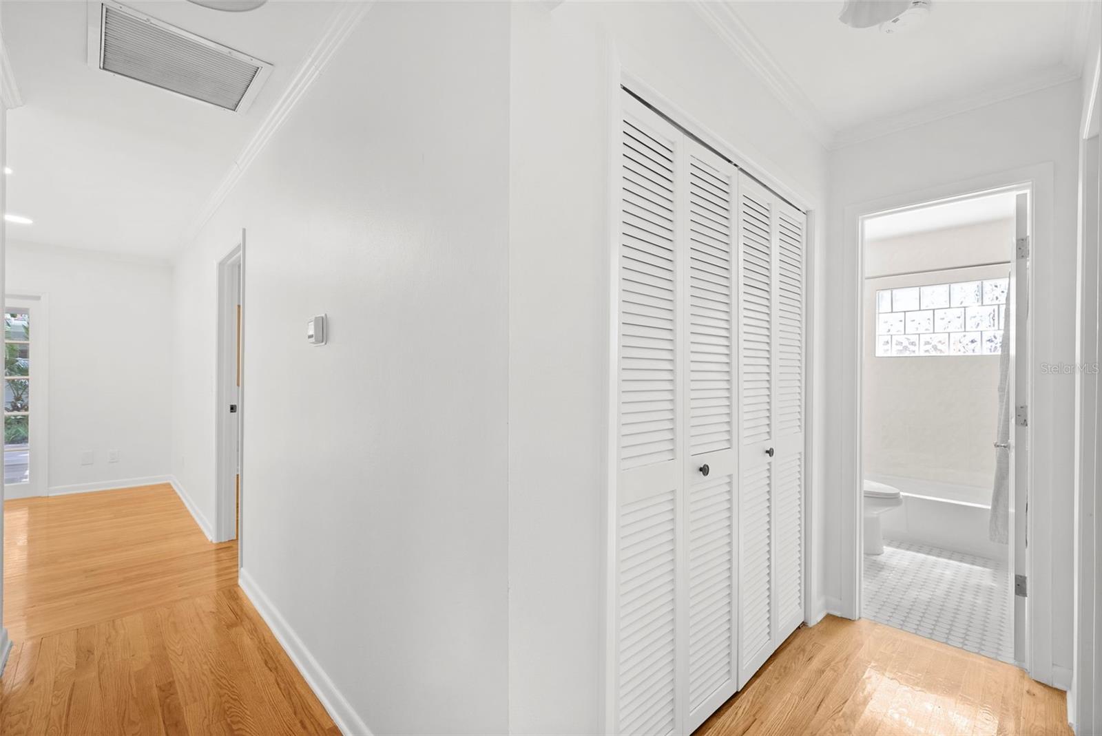 hall leading from the master in the back of home to front rooms