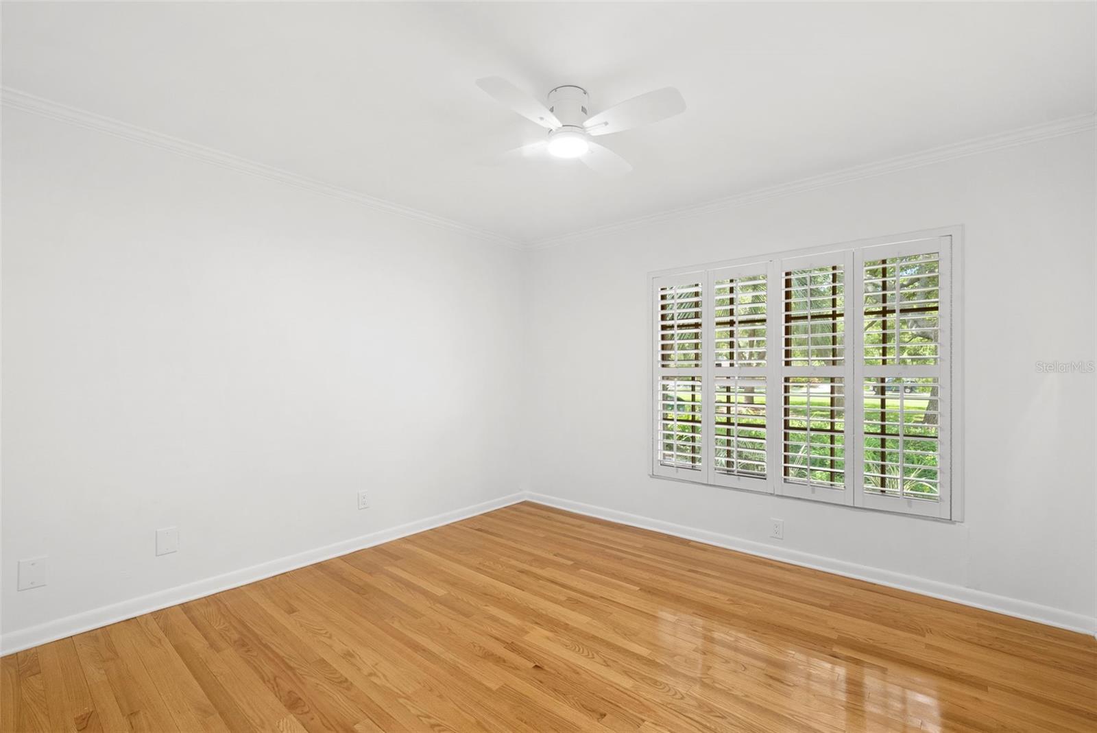 Bedroom w/ large windows to front of home