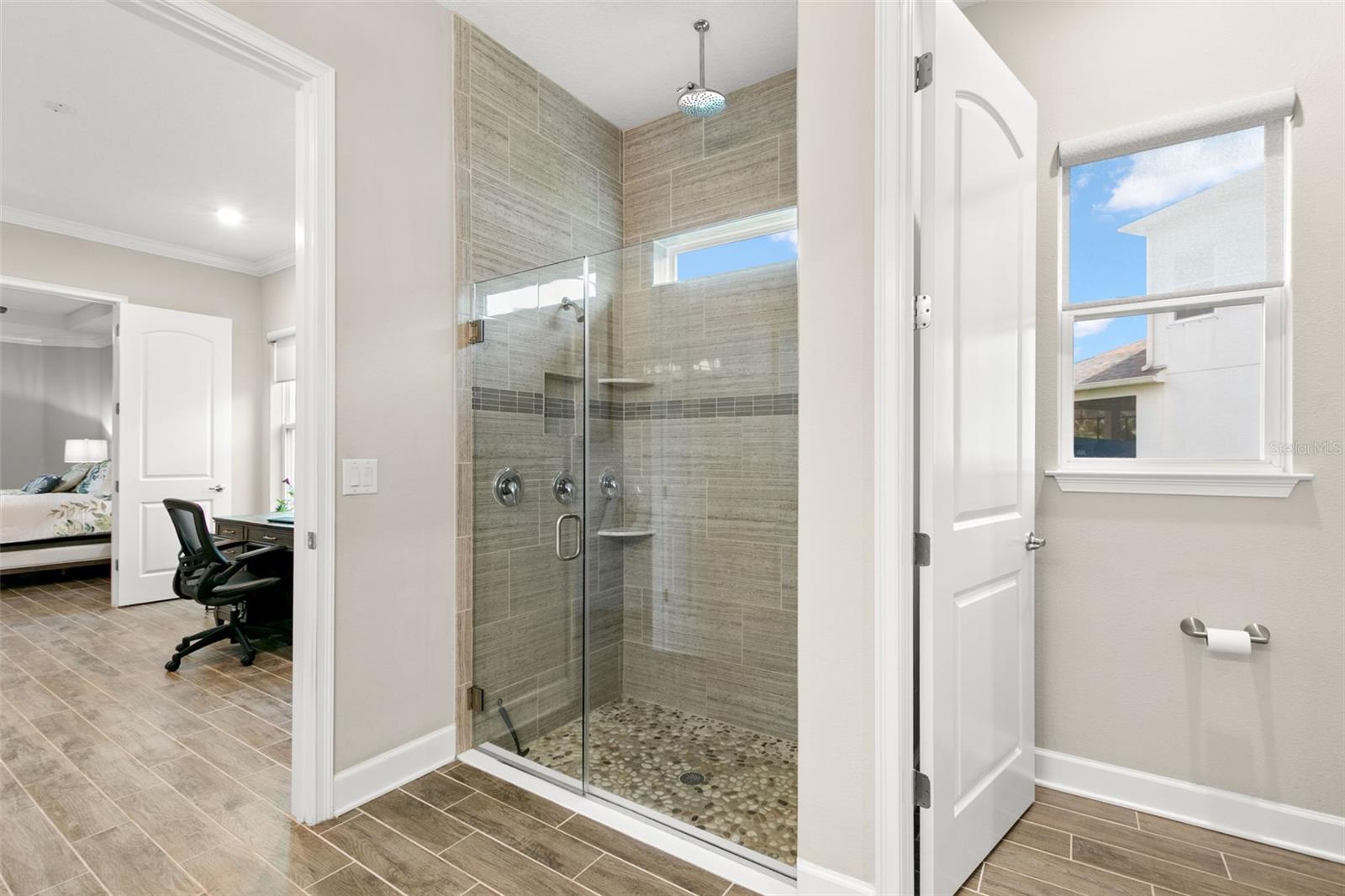First floor primary walk-in closet with washer/dryer