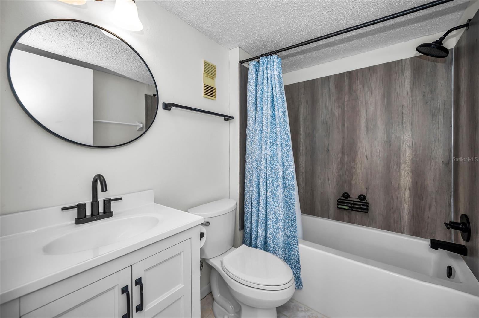 Guest bath with bath/shower combo and a modern look