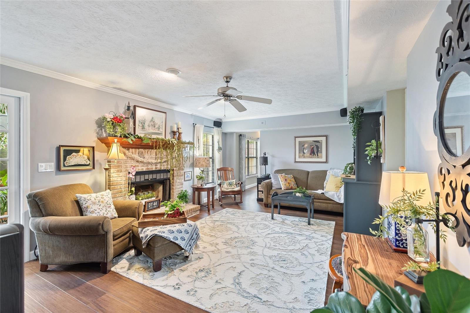 The cozy family room is located between the kitchen and the home office.  The wood burning fireplace makes a great focal point and decorative punch!