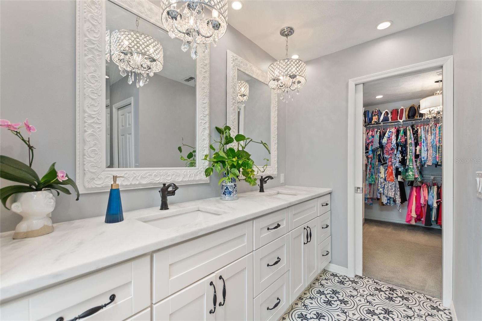 This master ensuite is just stunning!  Double sink vanity with marble counter tops.  The tile floor is heated!  There is under cabinet lighting at the base.  The walk-in closet is the largest of two.