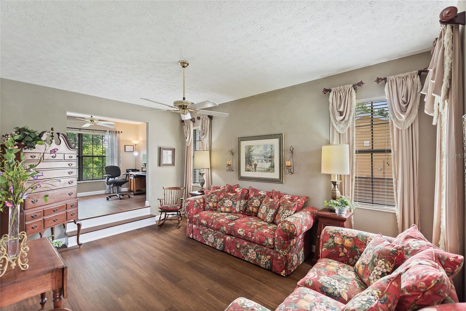 Formal living/sitting room that is open to the home office.