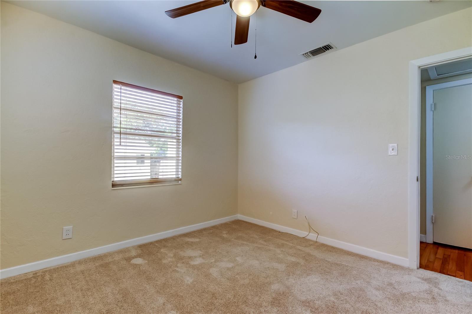 Second bedroom showing hallway linen closet.