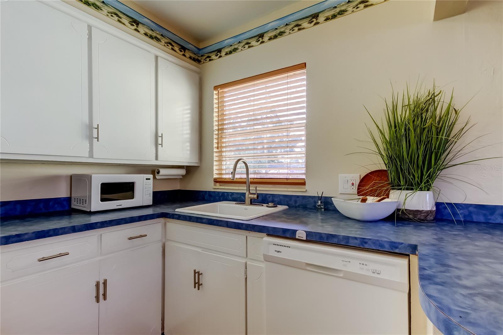 Kitchen showing microwave and dishwasher.