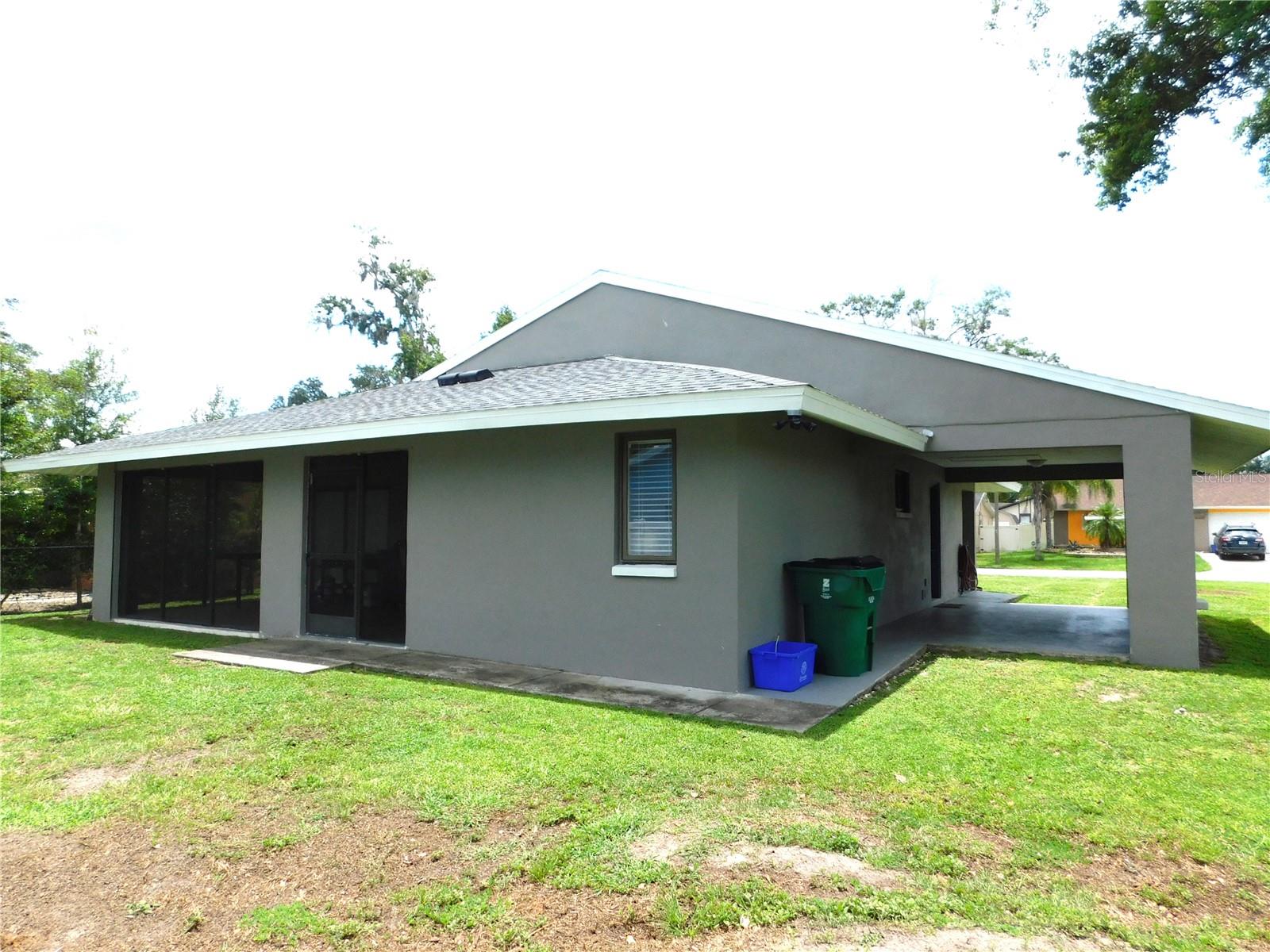 Back of home with Carport