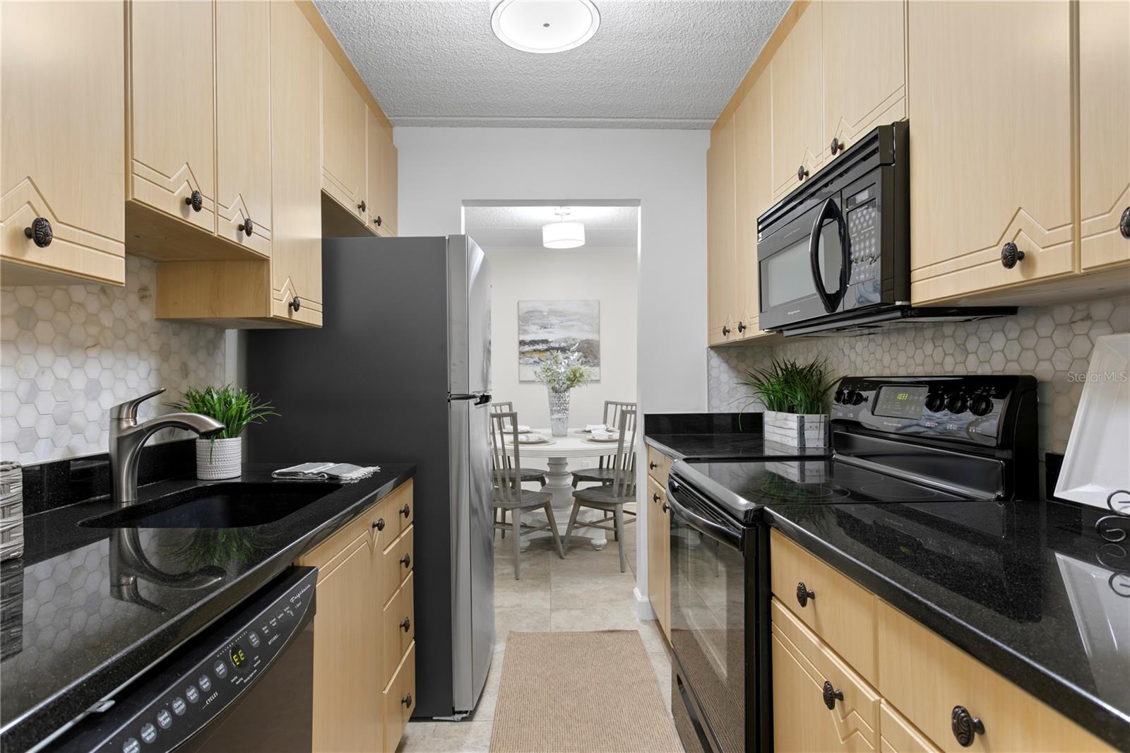 Updated kitchen with a new refrigerator, granite countertops and a nicely sized organized closet for additional pantry storage.