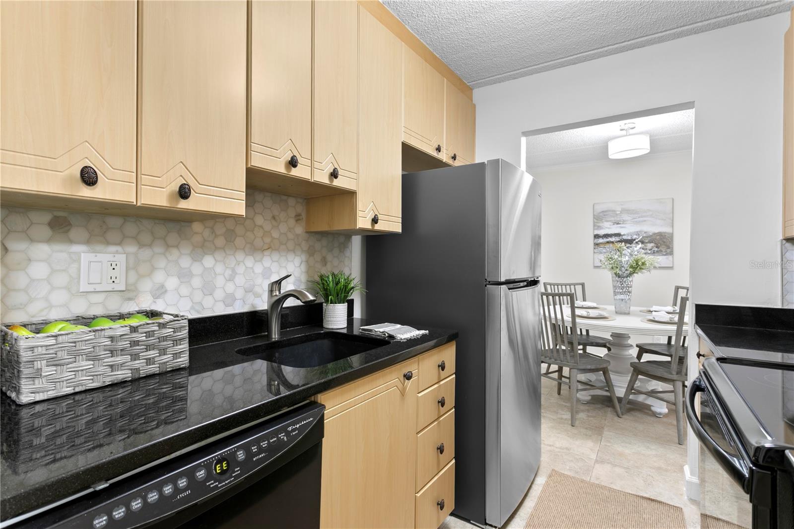 Updated kitchen with a new refrigerator, granite countertops and a nicely sized organized closet for additional pantry storage.