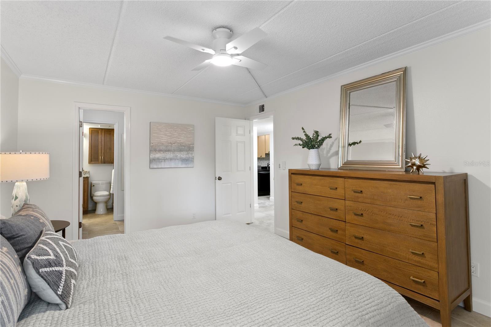 Spacious primary retreat featuring a walk-in closet and private en suite bathroom.
