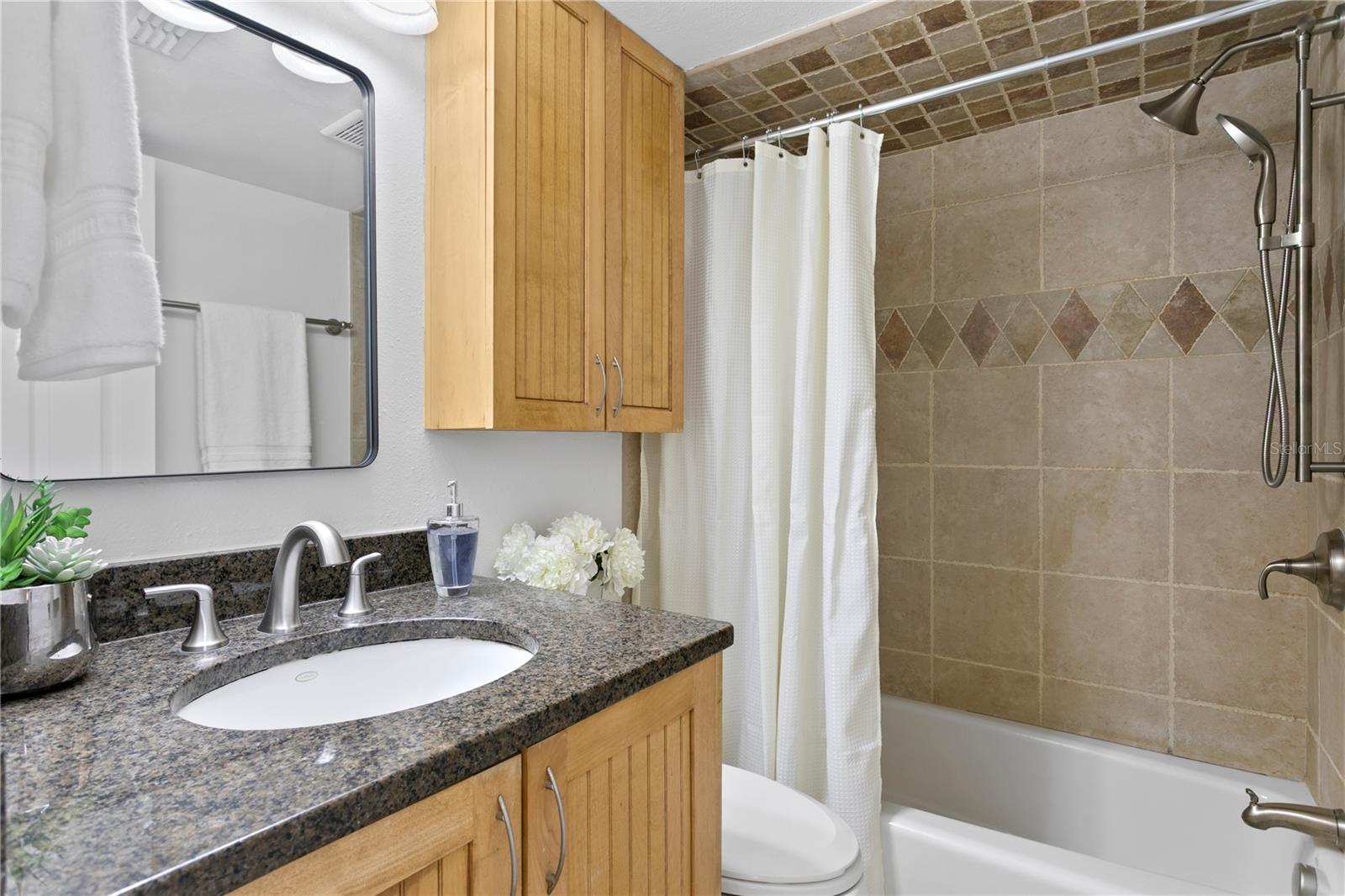 Convenient full bathroom located off the hallway—perfect for guests or secondary bedroom use