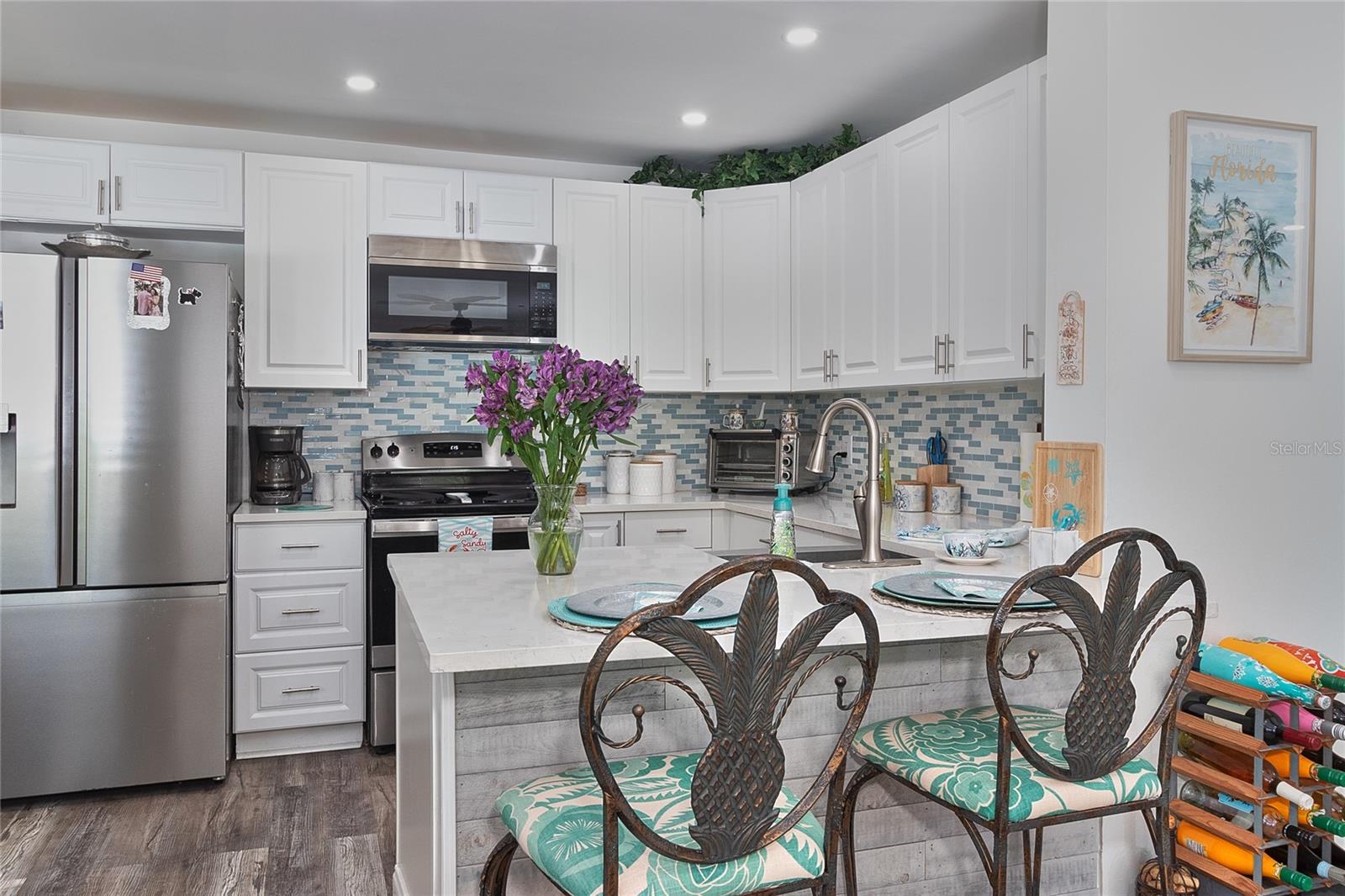 Sleek white kitchen with quartz counters.
