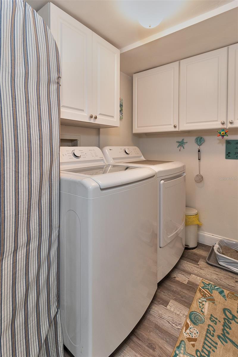 Laundry room with concealed tankless hot water heater