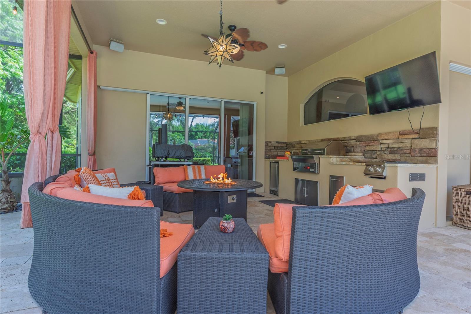 Outdoor living room connects to the bonus room through sliding glass doors.
