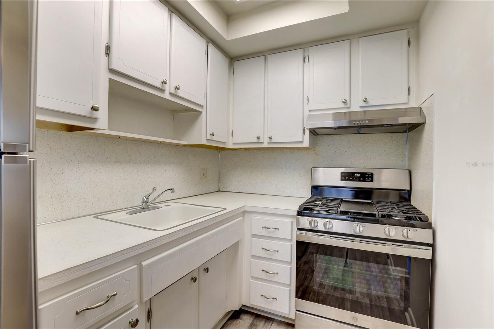 Kitchen with new gas range and new refrigerator
