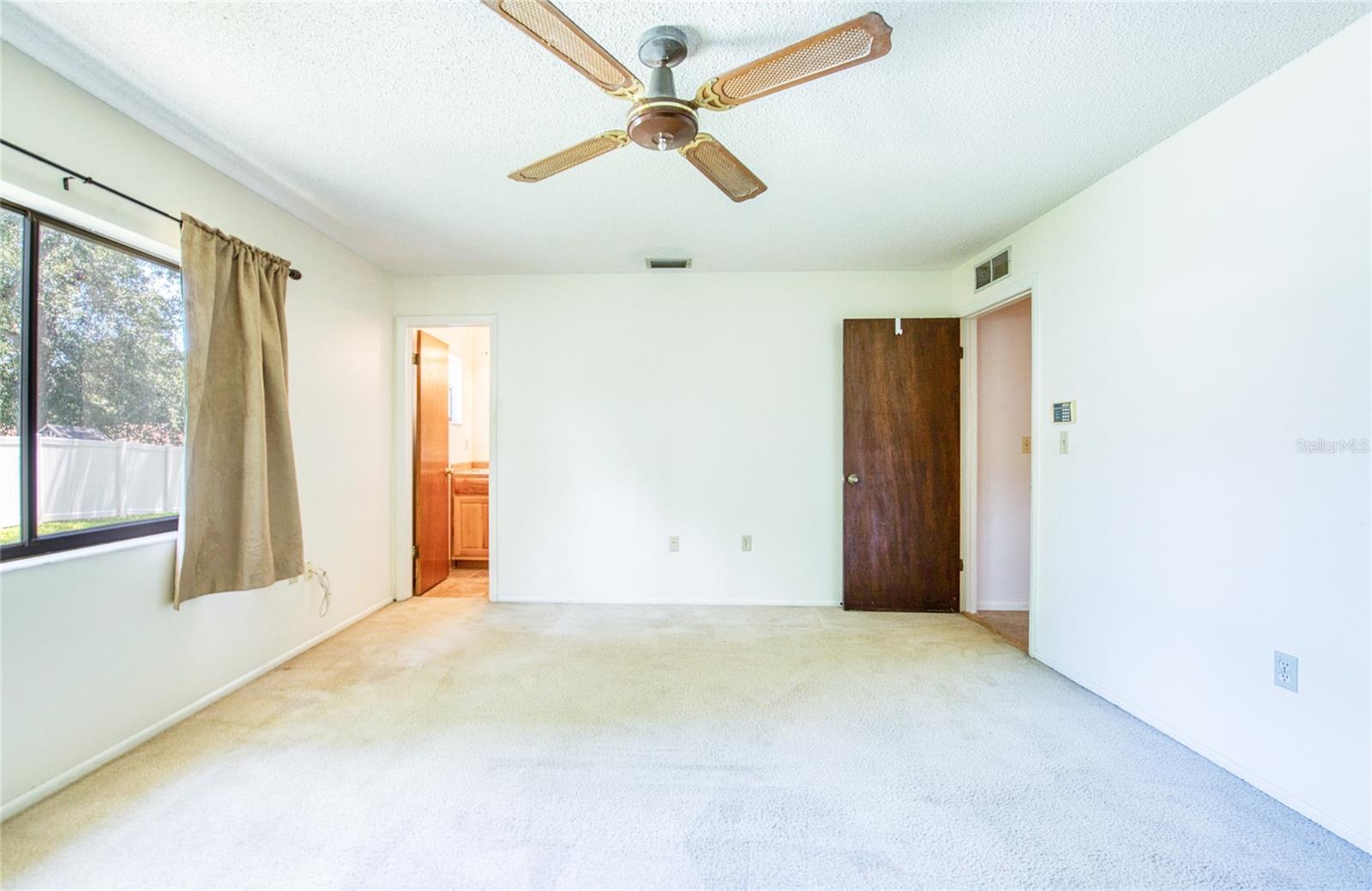Another view of Primary bedroom with view of primary bathroom