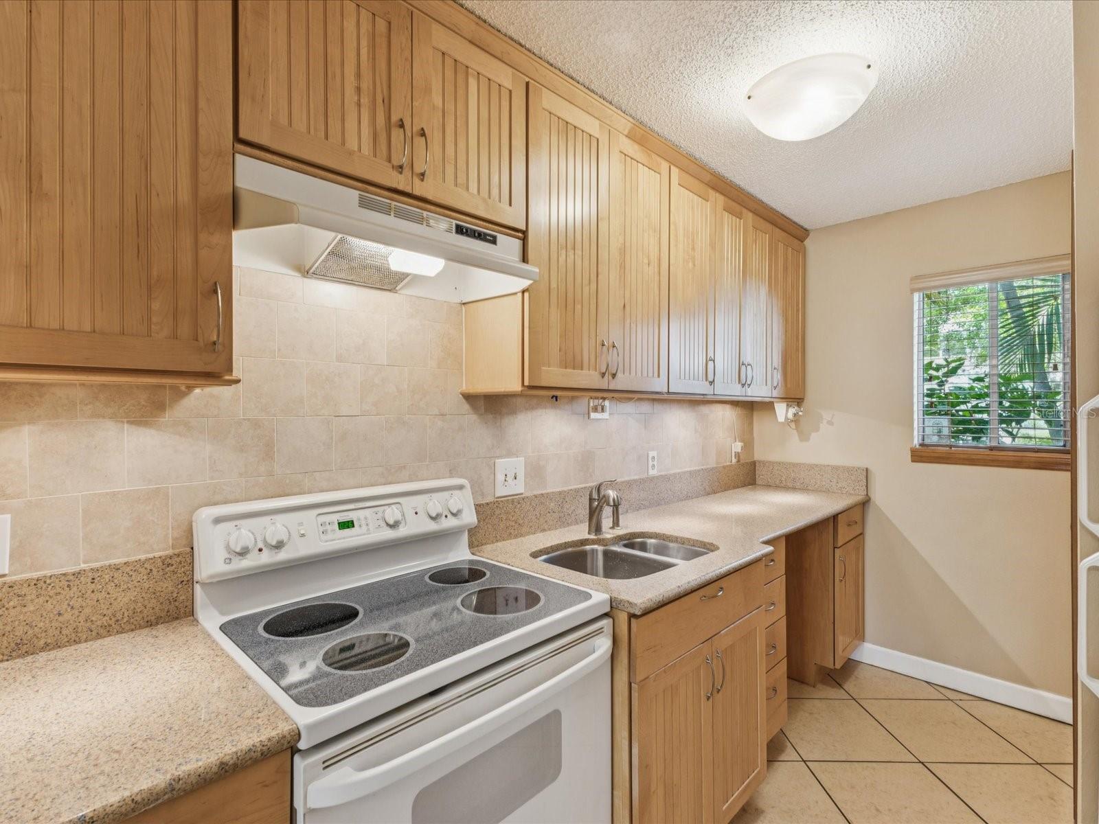 Electric range with space for dishwasher on the other side of the sink
