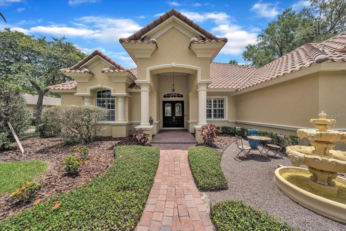 Impeccable curb appeal with lush landscaping and elegant lighting!