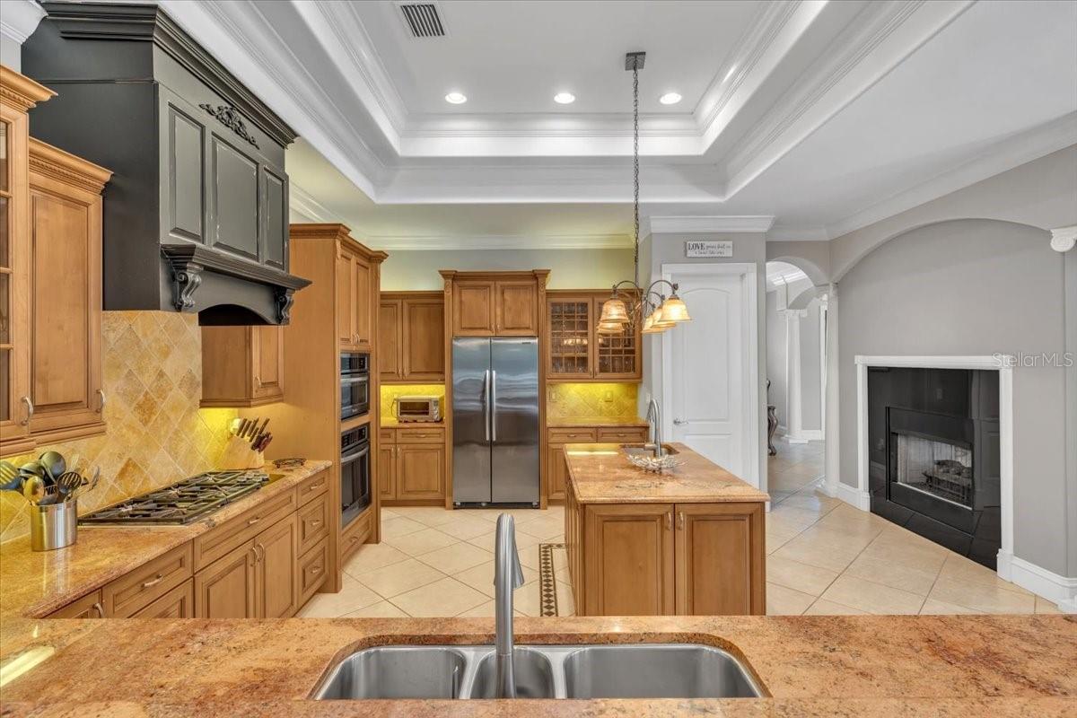 Gourmet kitchen with rich maple cabinetry, granite countertops, and Wolf gas burner!