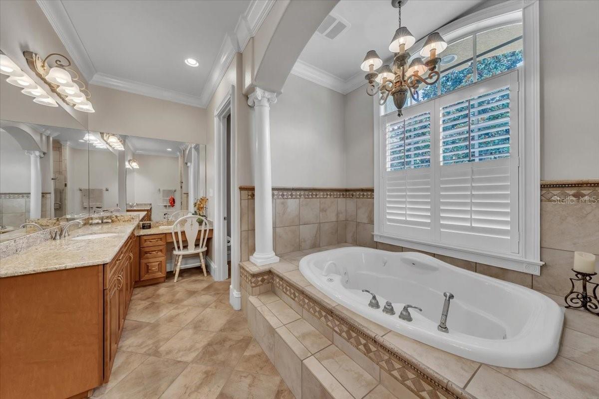 Spa-like en suite bath with jetted tub, frameless glass shower, and elegant finishes!