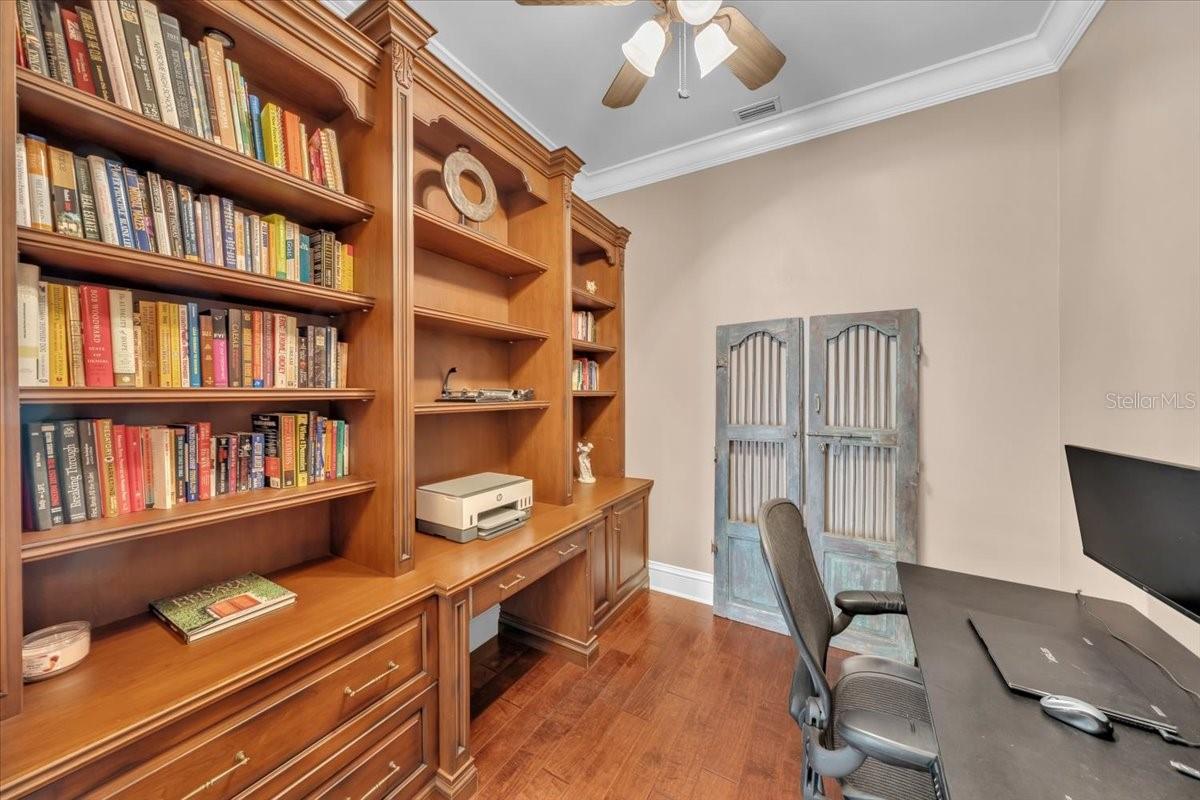 Custom built-in desks and shelving create a smart and stylish workspace