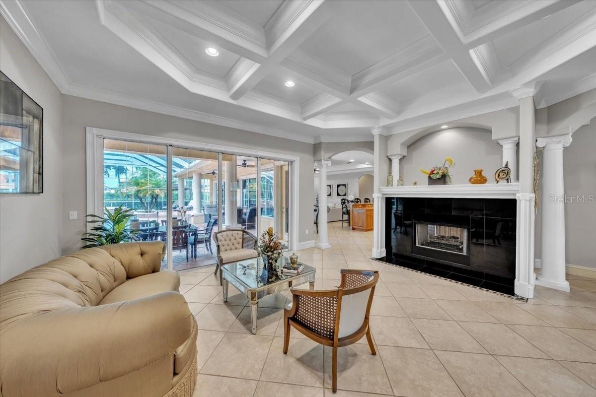 Formal living room with honeycomb ceiling and double-sided fireplace!
