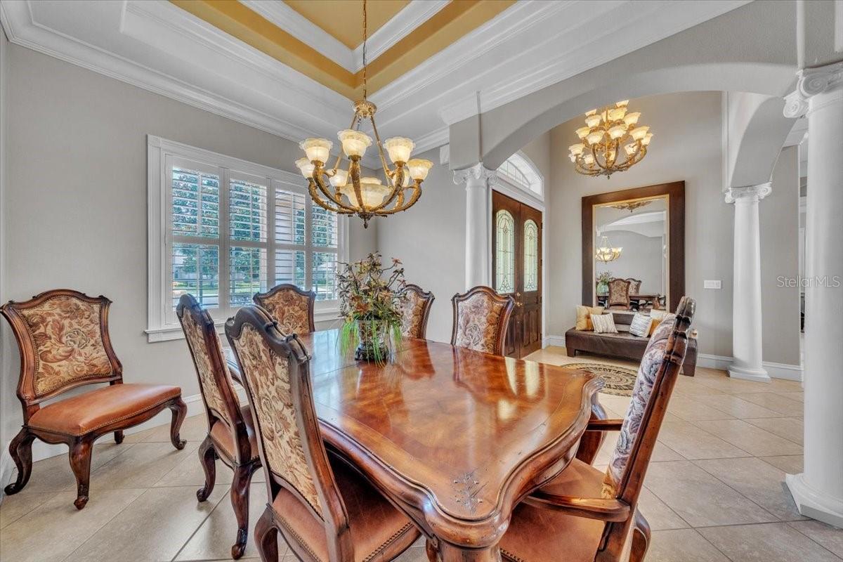 Stately columns and a crown-trimmed tray ceiling define this formal space!