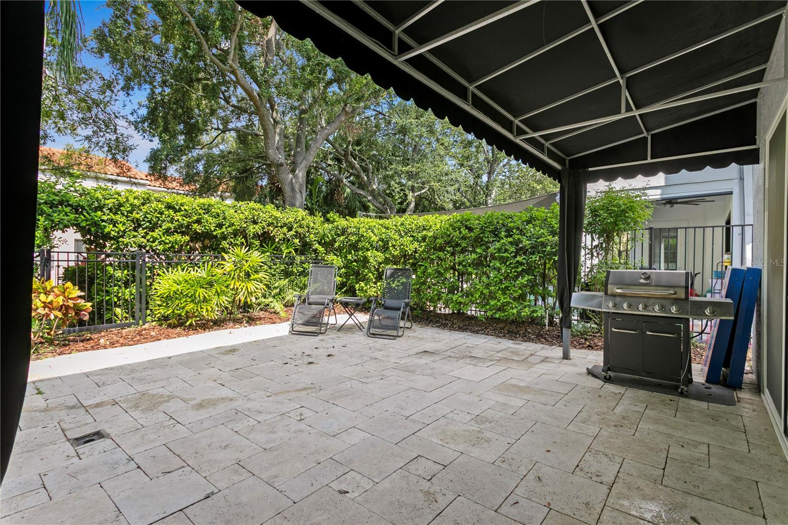 You can enjoy the shade provided by the awning, with plenty of space for a grill and outdoor seating.