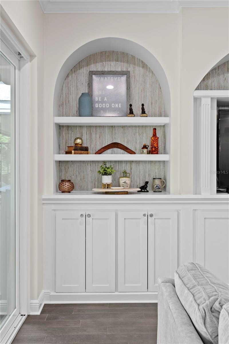 Elegant arch detailing above the built-ins enhances the space with a touch of charm and character