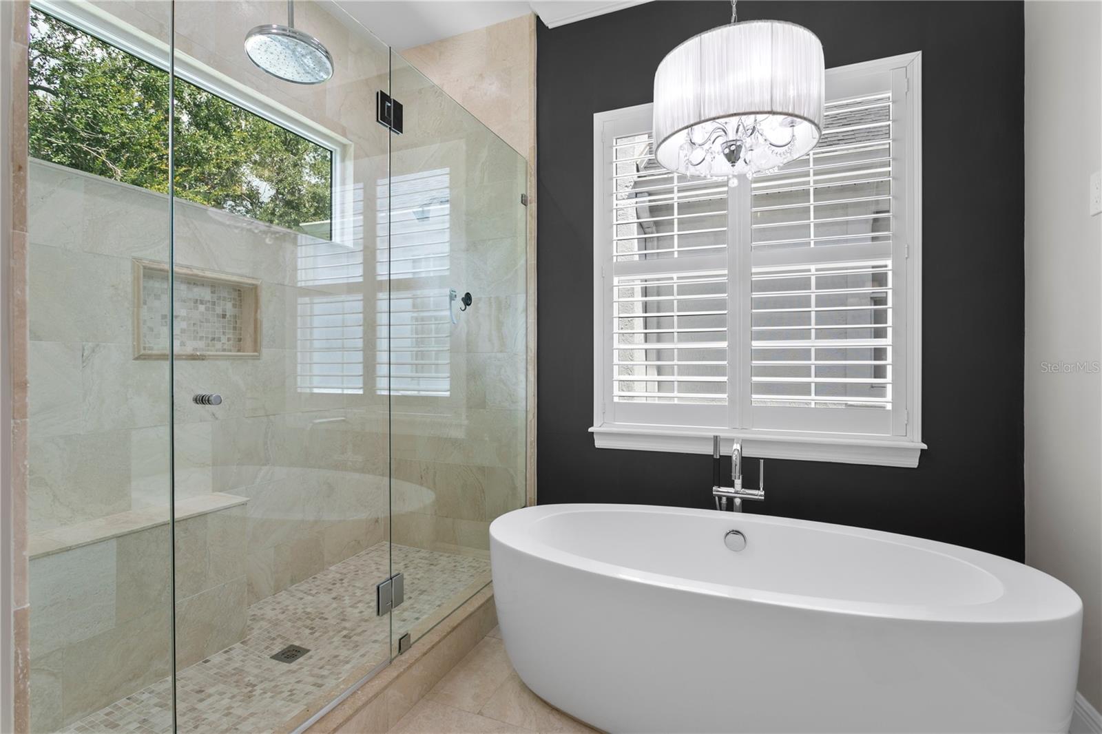 GORGEOUS MARBLE master bath offering an OVERSIZED walk-in shower, separate SOAKING tub, and dual vanities