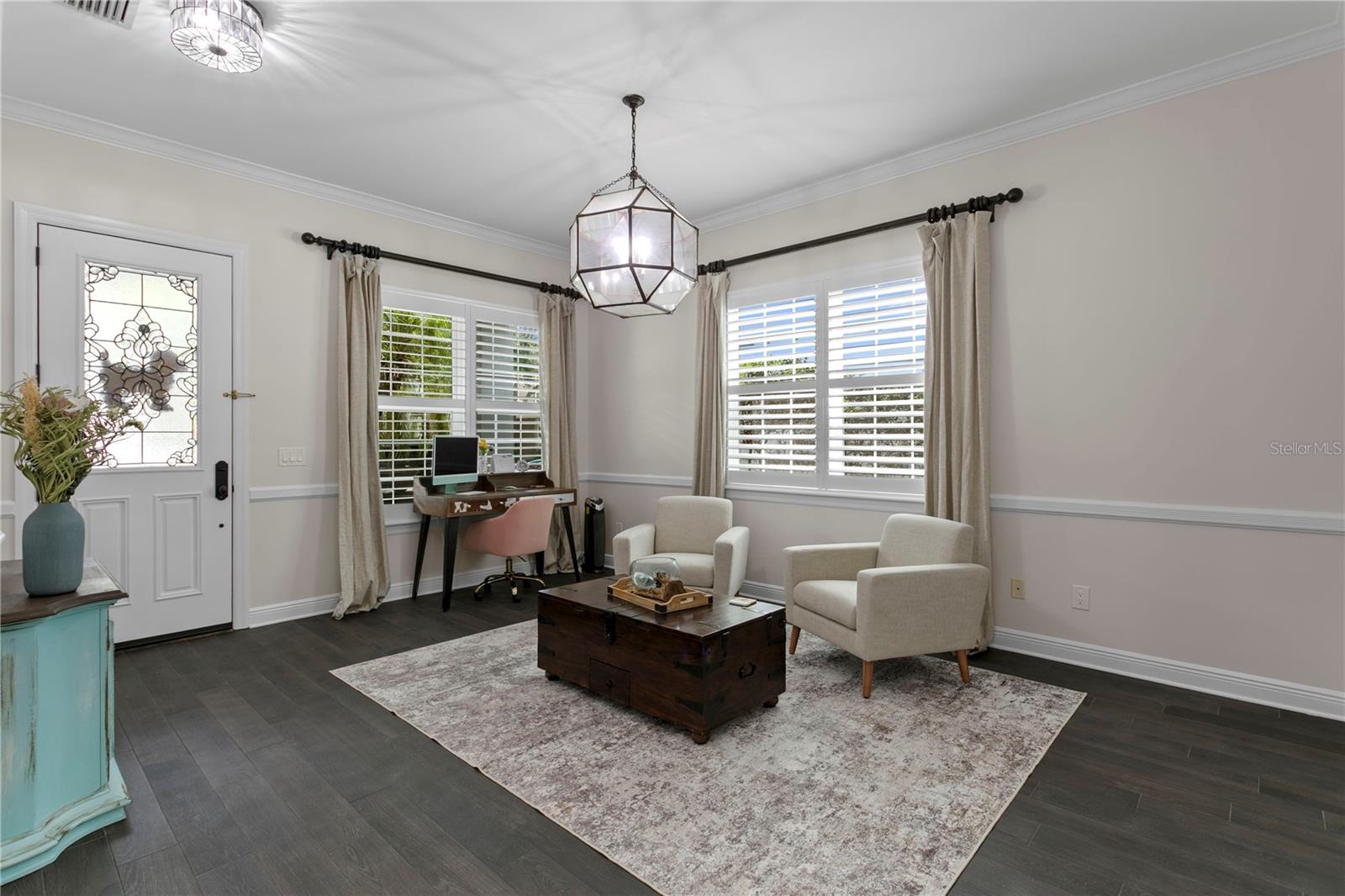 A functional front room ready to accommodate your needs—be it a cozy sitting space, productive office, or more