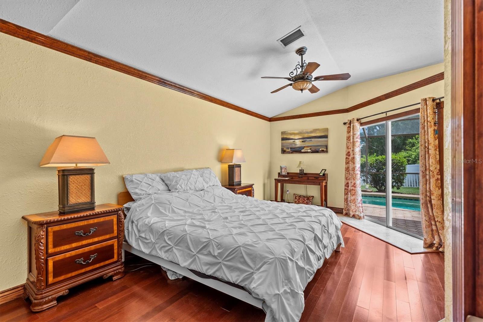 Primary bedroom with sliding doors to the pool area.