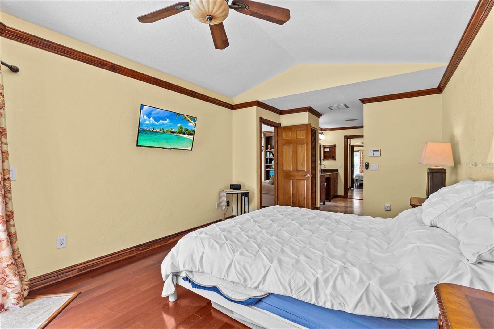Primary bedroom leading to the en suite bathroom with a walk in closet.