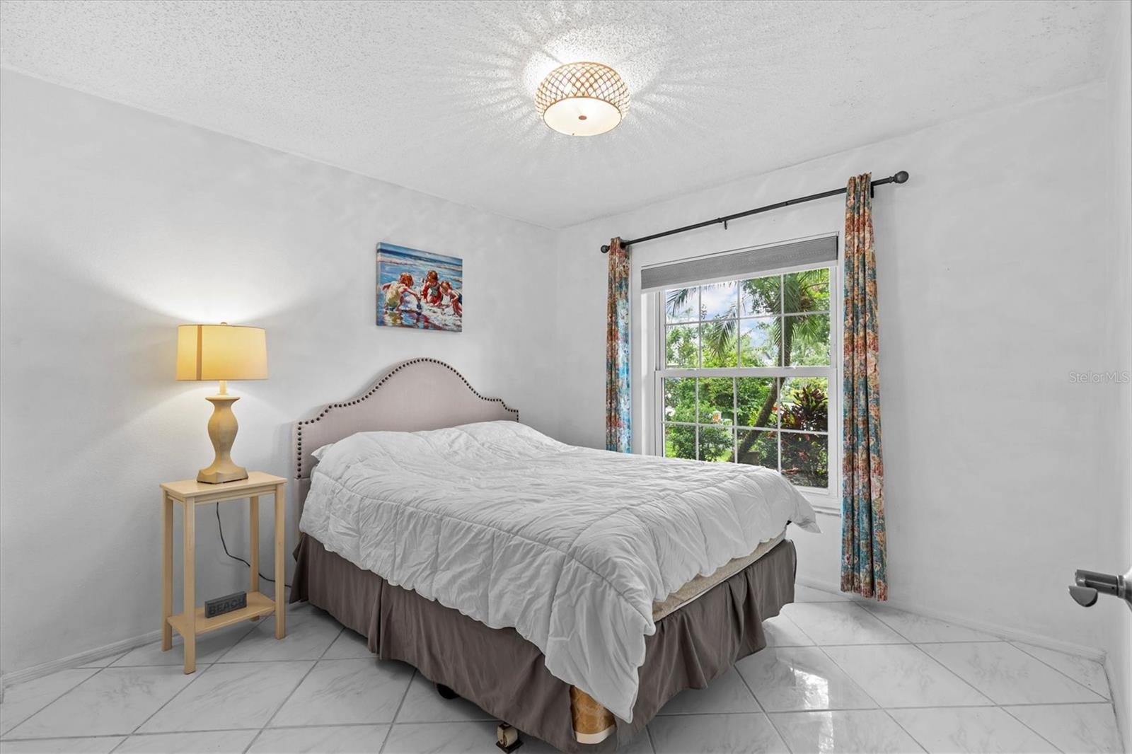 Bedroom 2, that measures 12x13 with tile floors.